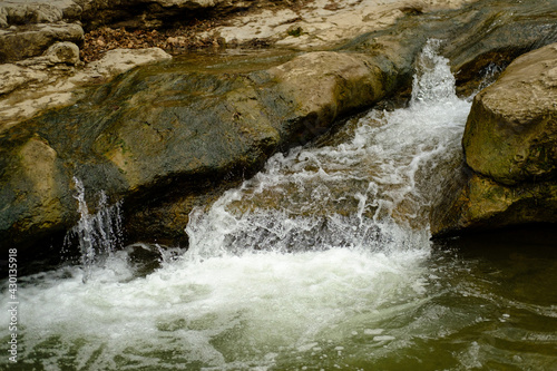 A clear mountain stream. Small waterfall