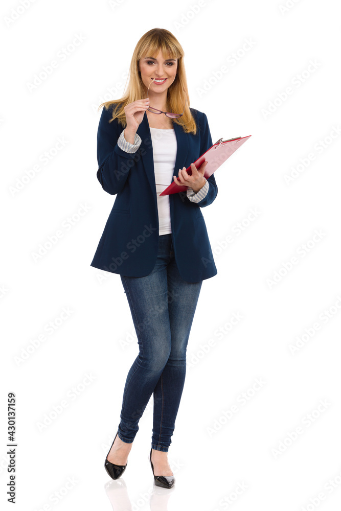 Smiling Young Businesswoman Is Standing With Clipboard Smiling Young Businesswoman Is Standing With Clipboard