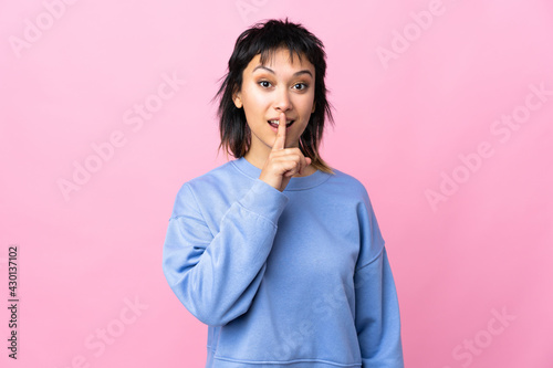 Young Uruguayan woman over isolated pink background showing a sign of silence gesture putting finger in mouth