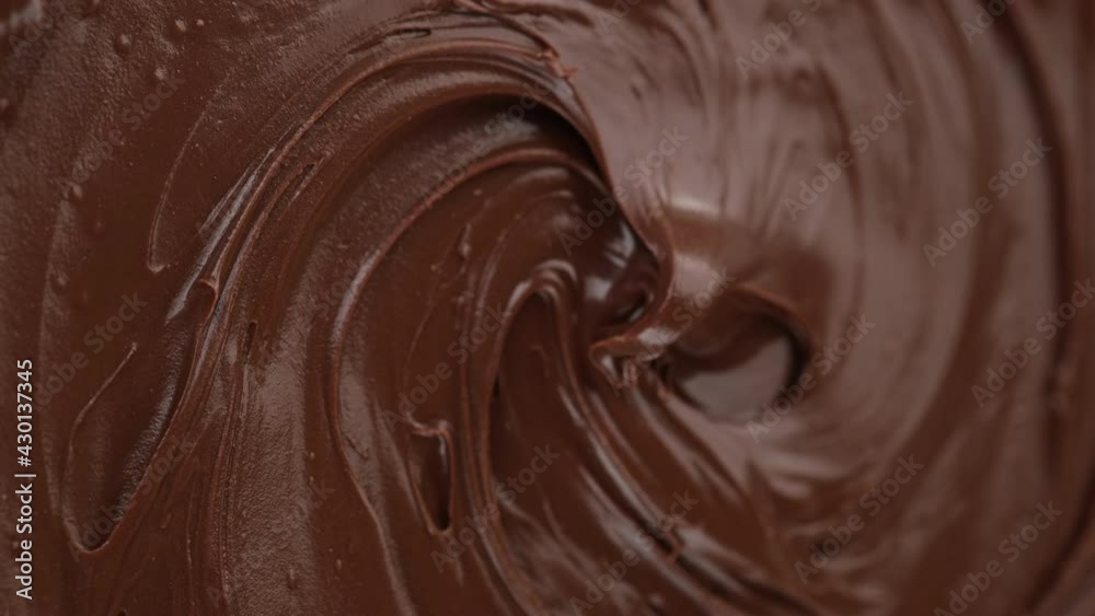 melted premium chocolate top view rotating. Confectionery concept. vertical video. 4K UHD video melted premium chocolate top view rotating. Confectionery concept. vertical video. 4K UHD video