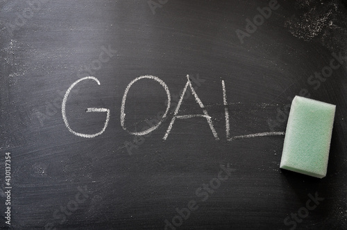 erasing goal, hand written word on blackboard being erased concept