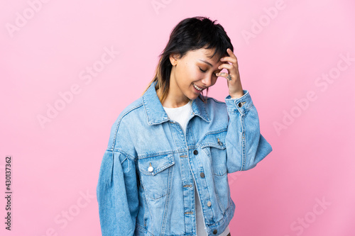 Young Uruguayan woman over isolated pink background laughing © luismolinero