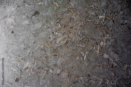 background marble surface of gray color with golden shade of texture