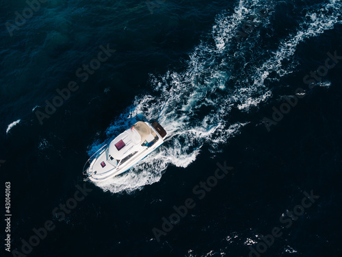 White motorboat floats on the open sea. View from above © Nadtochiy