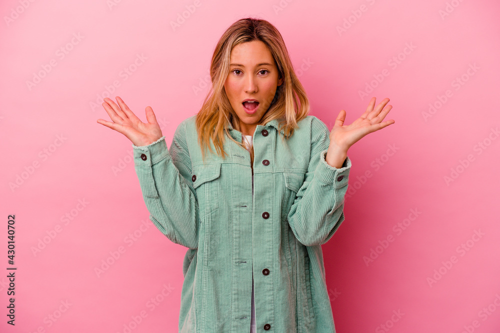 Young mixed race woman isolated on pink background surprised and shocked. Young mixed race woman isolated on pink background surprised and shocked.
