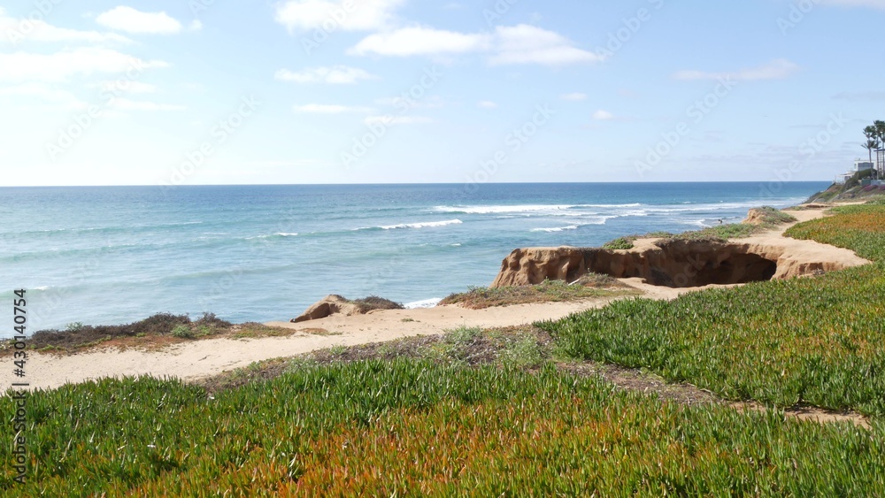 Seascape vista point, viewpoint in Carlsbad, California coast USA. Frome above panoramic ocean tide, blue sea waves, steep eroded cliff. Coastline shoreline overlook. Green ice plant succulent lawn.