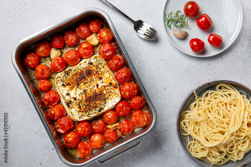 Tableau sur toile Oven baked feta pasta made of cherry tomatoes, feta cheese, garlic and herbs
