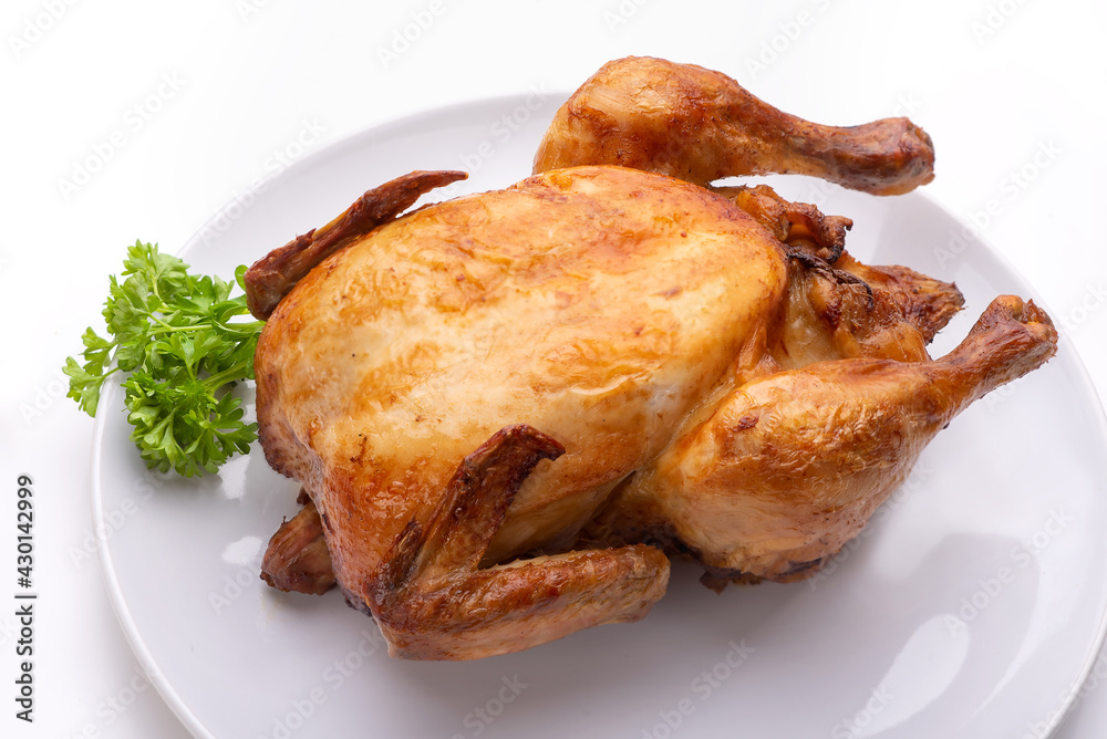 Baked chicken on a white plate. Isolate Baked chicken on a white plate. Isolate