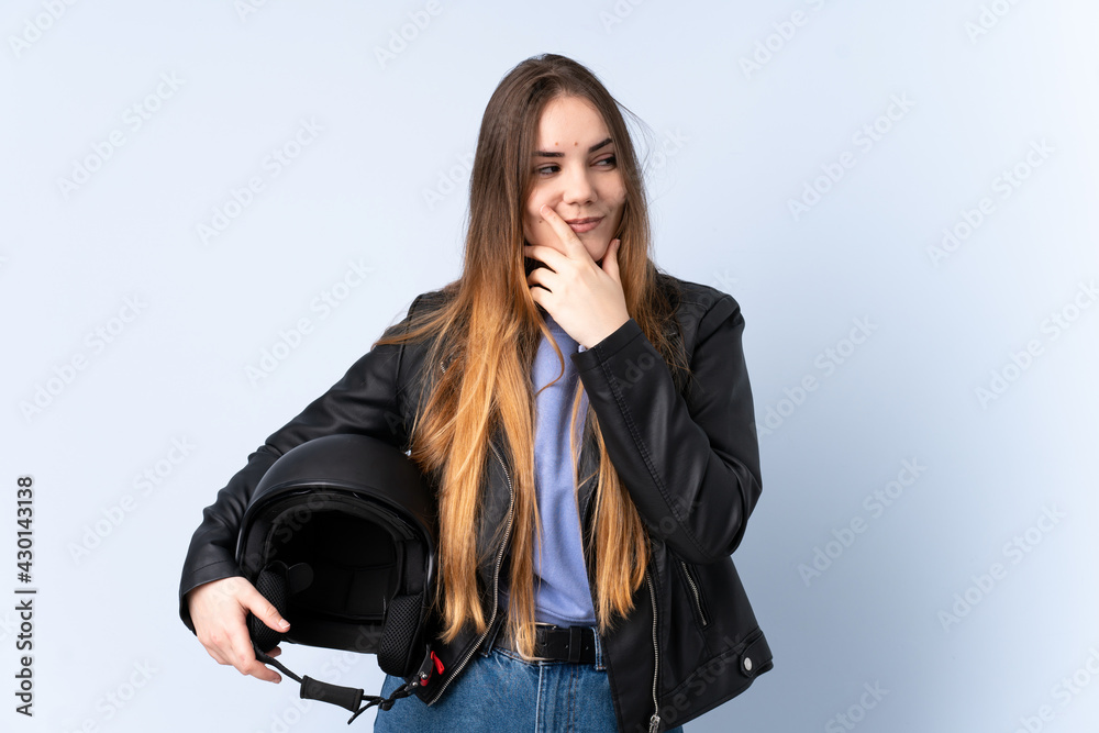 Woman with a motorcycle helmet thinking an idea Woman with a motorcycle helmet thinking an idea