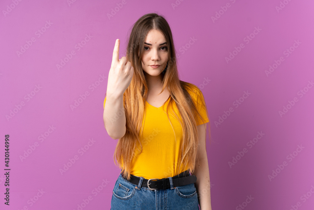 Young caucasian woman isolated on purple background doing coming gesture Young caucasian woman isolated on purple background doing coming gesture