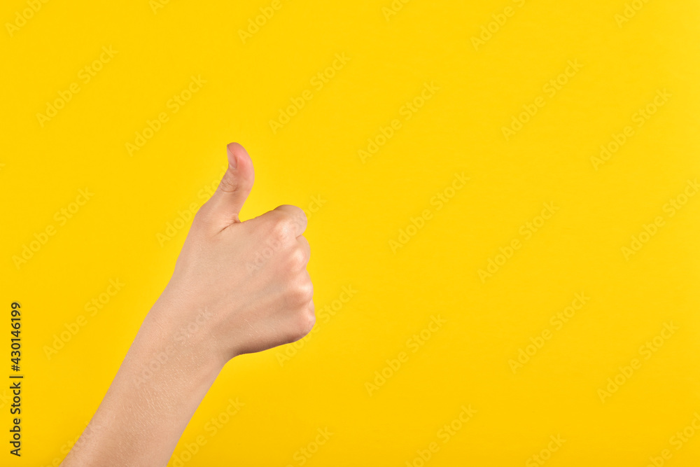 Childrens hands showing okay gesture on yellow background. Communication without words. Excellent