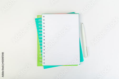 top view of an open notebook with a pen on a gray background, school notebooks with a spiral spring, office notepad. desktop concept, learning