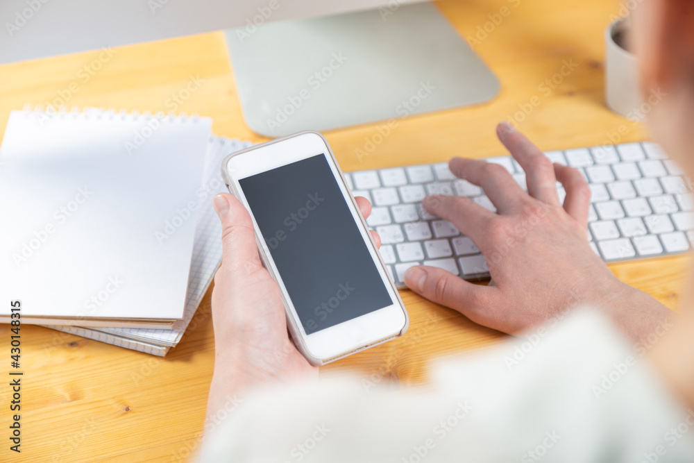 hands of women who use laptop keyboard and mobile phone. concept of email delivery and use of online technology hands of women who use laptop keyboard and mobile phone. concept of email delivery and use of online technology