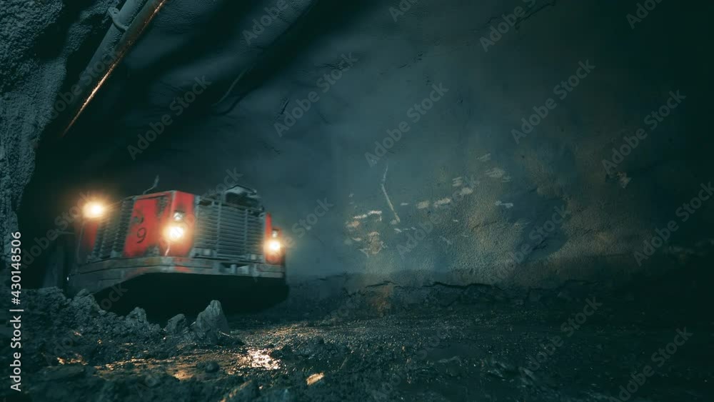 Minery tunnel with industrial machinery moving through it