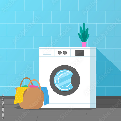 washing machine with a basket of dirty linen. laundry room interior.