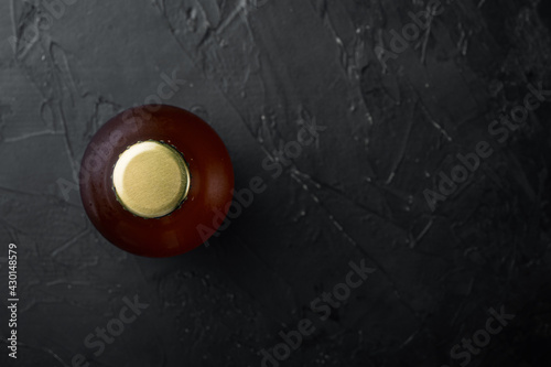 Beer bottle  on black stone background  top view flat lay  with copy space for text