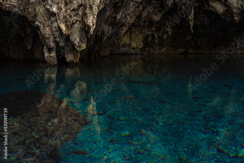 Lake in the cabe of blue clear and calm water with reflection. Travel and adventure concept 
