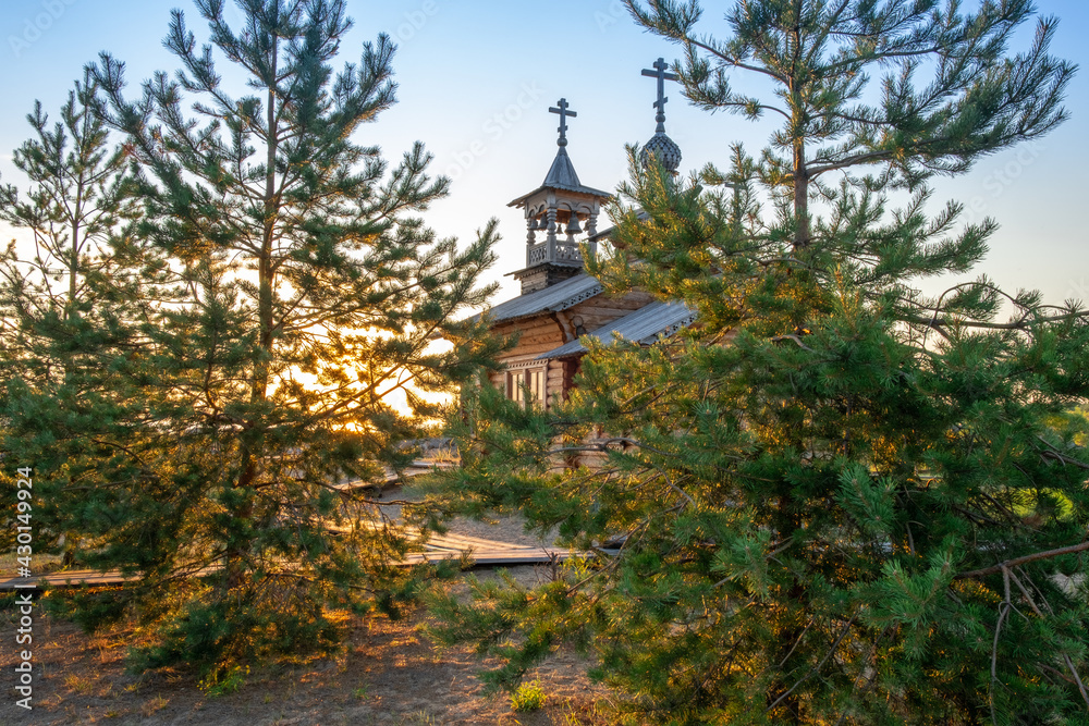Small wooden russian orthodox church. Wooden orthodox church against blue sky on sunny day
