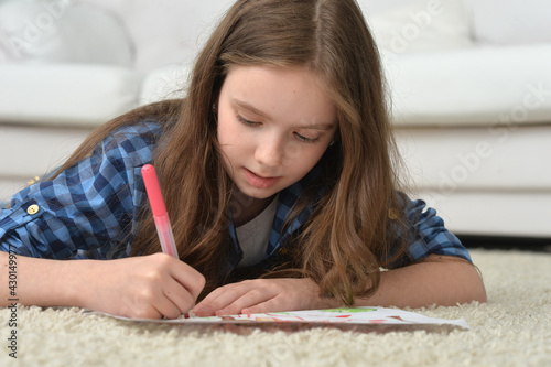 cute smiling girl drawing at home