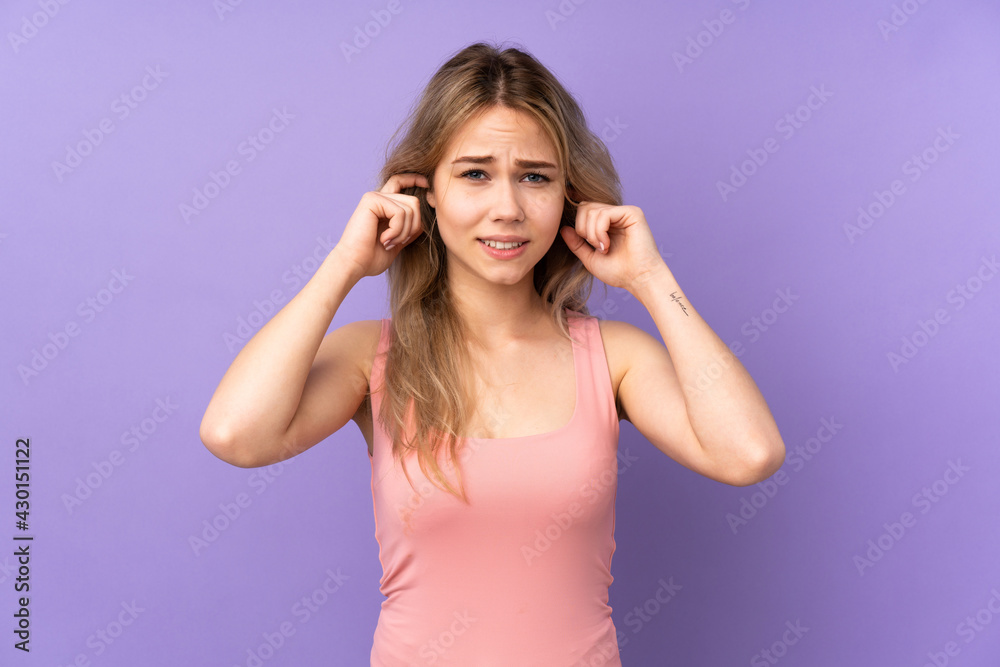 Teenager Russian girl isolated on purple background frustrated and covering ears Teenager Russian girl isolated on purple background frustrated and covering ears