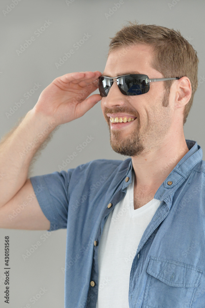 Portrait of handsome young man posing in sunglasses Portrait of handsome young man posing in sunglasses