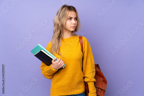 Teenager Russian student girl isolated on purple background portrait