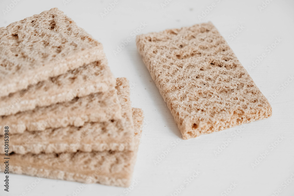 Stacked rye crisp bread on a white wooden background. Copy, empty space for text Stacked rye crisp bread on a white wooden background. Copy, empty space for text