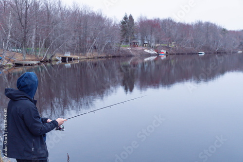 Man reeling in the fish , fishing in fresh water lake