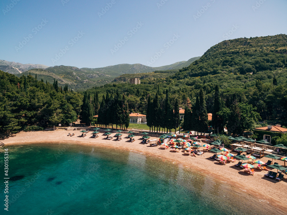 View of the royal beach of Przno in Montenegro against the backdrop of green slopes