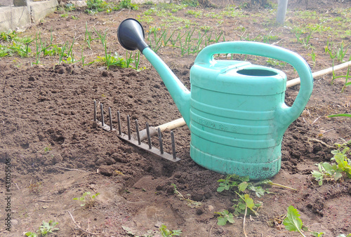 garden tools for working in the garden. Watering can, shovel, rake.