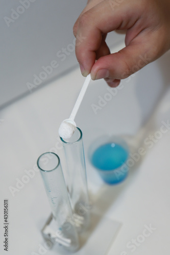 home experiments in chemistry in powder, test tubes and blue liquid, we study the reaction of chemical elements, we learn chemistry in practice