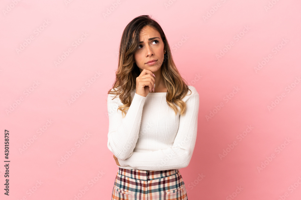 Young woman over isolated background and looking up Young woman over isolated background and looking up