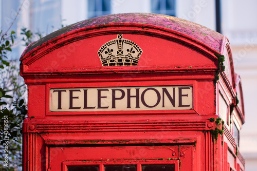 Vintage red telephone box close-up. Word telephone from London UK