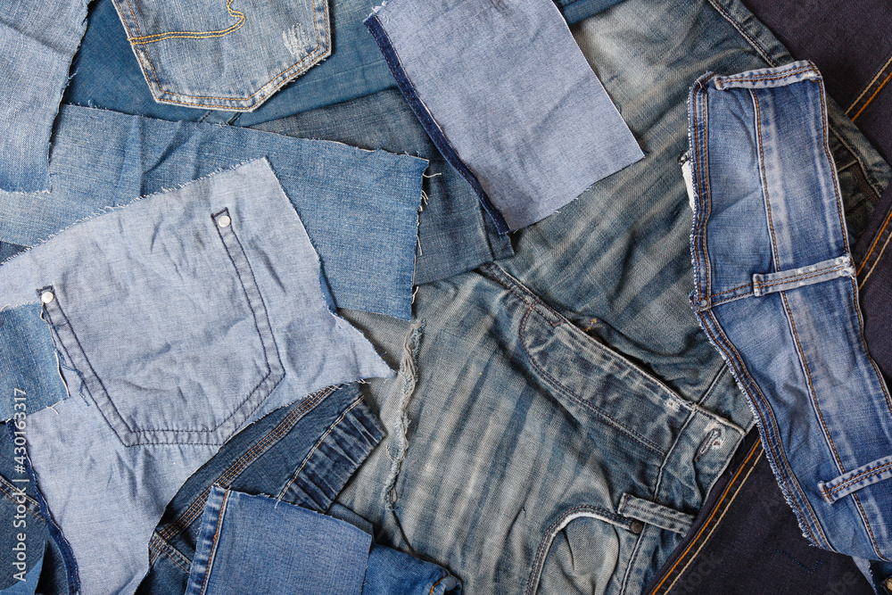 Old denim garbage background. Recycling old jeans. Old blue jeans ready for  recycling on wooden table. Denim upcycle. Circular economy. Pile of  discarded old blue jeans. Zero waste Photos | Adobe Stock