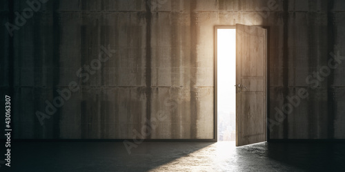 New career and opportunities concept with light entering through open door in dark room with concrete floor