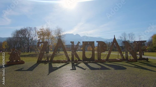 Zakopane big letters in front of mountain view in sunny autumn day in Zakopane, Poland