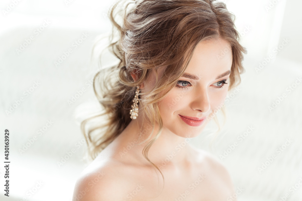 Bride Wedding Portrait. Bridal Hairstyle. Wedding Makeup. Beautiful Woman Elegant Evening Wedding Hair Style. Beauty Model Face Side View over White Background Bride Wedding Portrait. Bridal Hairstyle. Wedding Makeup. Beautiful Woman Elegant Evening Wedding Hair Style. Beauty Model Face Side View over White Background