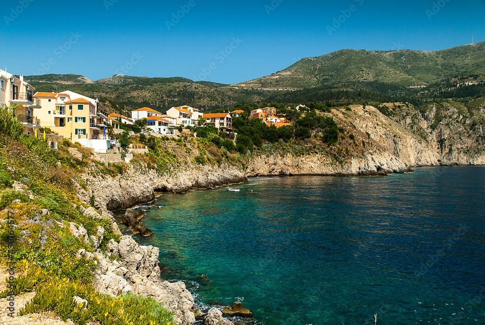 the  coastline of the island of Kephalonia  where the mountains meet the sea can be, like here, rocky with cliffs or a shallow sandy bay