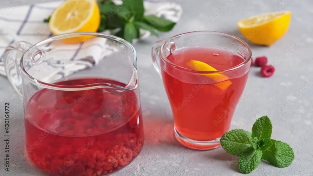 Mixing raspberry tea with lemon with spoon. Concept of a healthy diet, vitamin breakfast. Slow motion Mixing raspberry tea with lemon with spoon. Concept of a healthy diet, vitamin breakfast. Slow motion