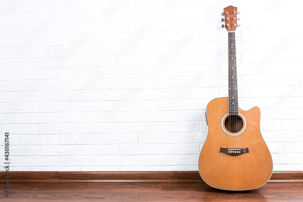 Fototapeta premium Guitar on a brick wall background