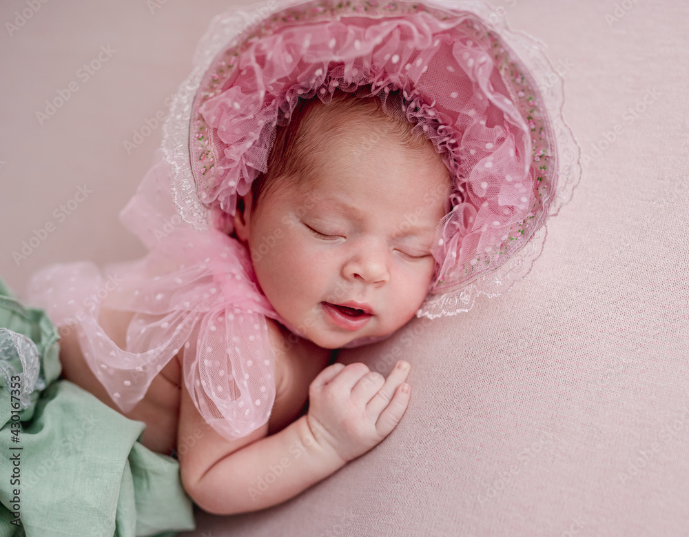 Newborn wearing lace cap and pantaloons Newborn wearing lace cap and pantaloons