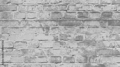 Abstract old white brick wall. background facade brick wall black and white. Vintage old brick wall texture. Grunge stone wall horizontal background. Dilapidated building facade with damaged plaster.
