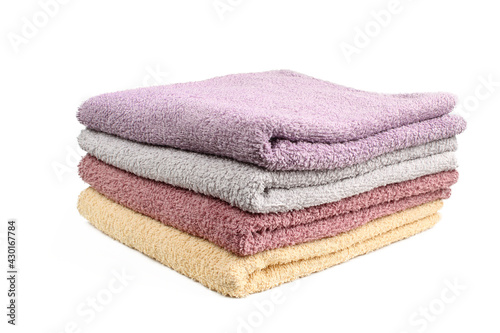 Stack of different color towels isolated on white background