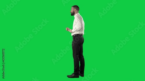 Happy carefree business man dancing listening electronic music. Full length on green screen chroma key background