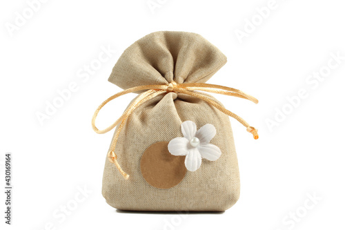 Brown bag filled with lavender, sachet and camelia flower isolated on white background. Dry herbal fragrance present