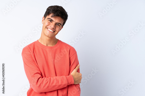 Handsome man over isolated blue background laughing
