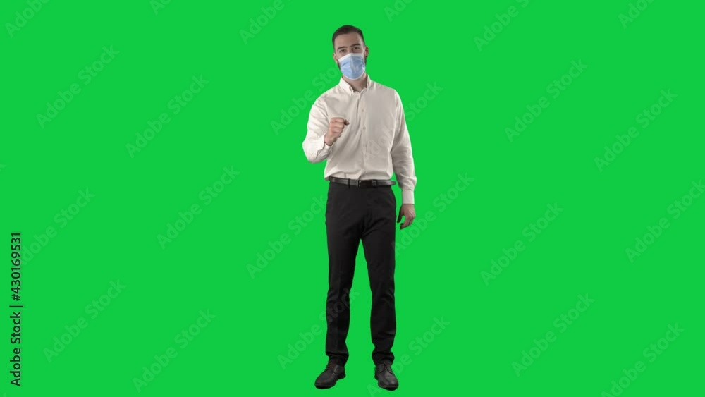 Business man with face mask greeting in new normal way with fist and elbow bump. Full length on green screen chroma key background Business man with face mask greeting in new normal way with fist and elbow bump. Full length on green screen chroma key background