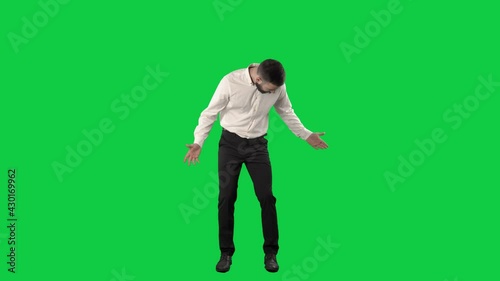 Clueless business man looking around searching for something lost. Full length on green screen chroma key background