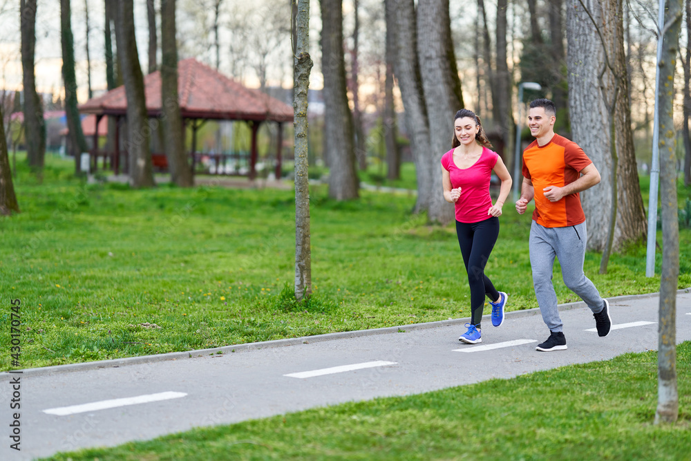 Young couple running in the park Young couple running in the park