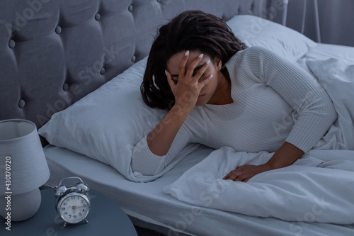 Photos Black woman suffering from insomnia covering face